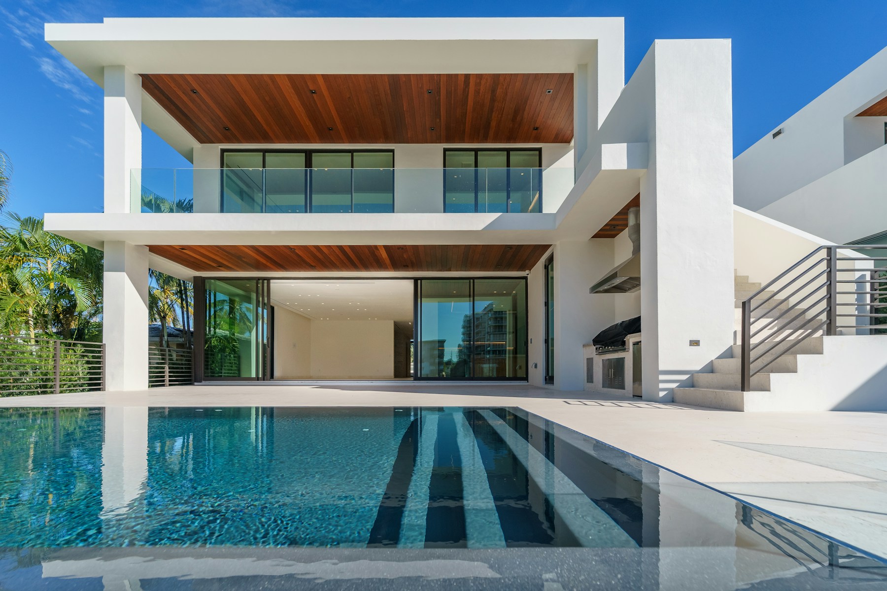 A sunlit white villa beside a blue swimming pool, offering inspiration for a future holiday